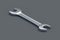 One spanner on black background. Metal wrench in workshop. Repair and maintenance tool