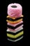 One stack of liquorice allsorts candy isolated on black background