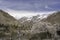 One storey stone farm house covered with cherry blossum tree among Passu village