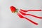 One strawberry and three red forks, minimalistic shot with selective focus