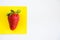 One strawberry on the yellow and white background, raw real strawberries