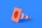 One striped traffic cone, barrier on blue background. Road safety