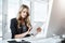 One tap away from a productive workday. a young businesswoman using a digital tablet at her desk in a modern office.