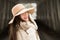 One teenage high school senior portrait wearing floppy hat at covered bridge in winter