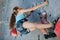 One teenager climbing a rock wall indoor.