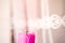 One thick pink candle, fire extinguished, object on a light background