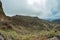 One of the tight turns of a narrow rural road in the mountains of Parque Natural Majona. View of the gorge and San Sebastian, the