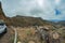 One of the tight turns of a narrow rural road in the mountains of Parque Natural Majona. View of the gorge and San Sebastian, the