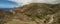 One of the tight turns of a narrow rural road in the mountains of Parque Natural Majona. View of Playa De Caleta the north-eastern