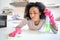 One tired black woman is cleaning domestic kitchen