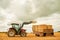 One on top of the other. a farmer stacking hale bales with a tractor on his farm.