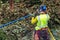 One tree trimmer with gear preparing to climb