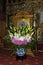 One vase with beautiful flower arrangement ikebana dedicated to Virgin Mary inside a church