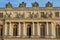 One wall of Versailles Castle in Paris, France with stunning statues of people