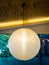 One Warmly colored balloon white paper lanterns hanging from th