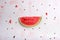One watermelon slice, seeds and juice stains afer eating on white background