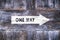 One way arrow sign on wooden background