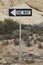 One way sign in desert. Small shrubs and rocks in background