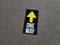 one way sticker sign on gray carpet or rug
