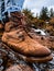 One wet cowboy boot stepping on the water in the mountains