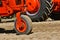 One wheeled old orange tractor