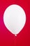 One white ball isolated on a red background, birthday decoration, valentines day, decor, red ball with shiny reflections