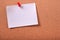 One white sticky post note pinned cork bulletin board background