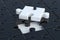 One white on unfinished black puzzle jiggle pieces. Educational games. Hobby and leisure