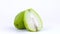 One whole and one half of chayote fruit. Rotating on the turntable. Isolated on the white background. Close-up.