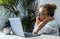 One woman doing yawn for tired and bored condition in front of an open laptop at the desk. Smart working online business and