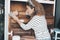 One woman refurbish old cabinet after relocation house. Female people doing handyman work at home renewing and renovating