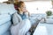 One woman relaxing inside camper van motorhome looking outside the view from the window. Traveler and freedom independence people