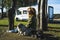One woman sitting on the ground with her two best friends dogs pug in travel stop with alternative house vanlife motorhome camper