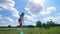 One woman training on a golf field, hitting a ball.