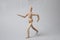 One wooden puppet with strings on light grey background