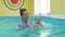 One year baby boy at his first swimming lesson