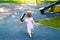 One-year child chasing a pigeon on playground