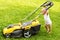 One year kid Grinding the grass with a grassmower