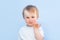 One year nine month old boy portrait on blue background