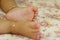 One year old baby boy`s cute feet
