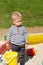 One year old baby boy toddler at playground sandbox