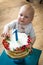 One year old boy and his birthday cake