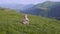 One year old boy learn to walk on the background of mountains