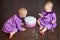 One year old twin girls selebrating they 1st birthday and eating smash-cake