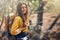 One young active caucasian woman wearing a backpack while out hiking in the forest. Young brunette female walking alone