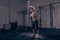 One young man, bodybuilder posing holding bar vertical