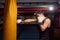 one young man, boxer hand hitting punching bag, practicing indoors gym room, wearing boxing gloves, upper body shot.