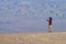 One young man takes a pictures in the desert with a smartphone