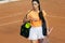 One young sportswoman, professional tennis player walking on clay court in bright summer day.