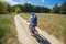 One young woman - an athlete rides on a mountain bike outside of town in a pine forest